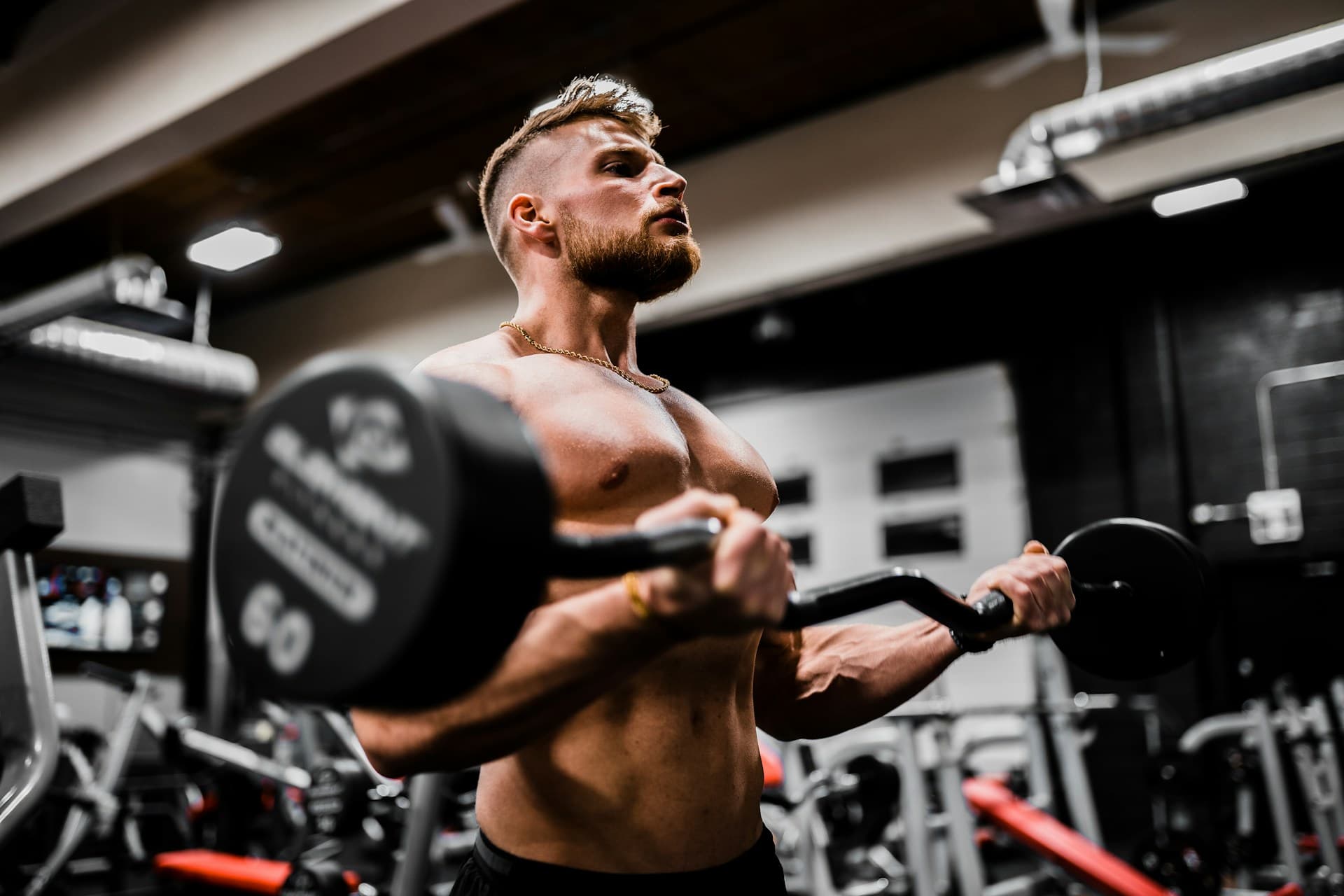 Athlete focused during a heavy barbell curl