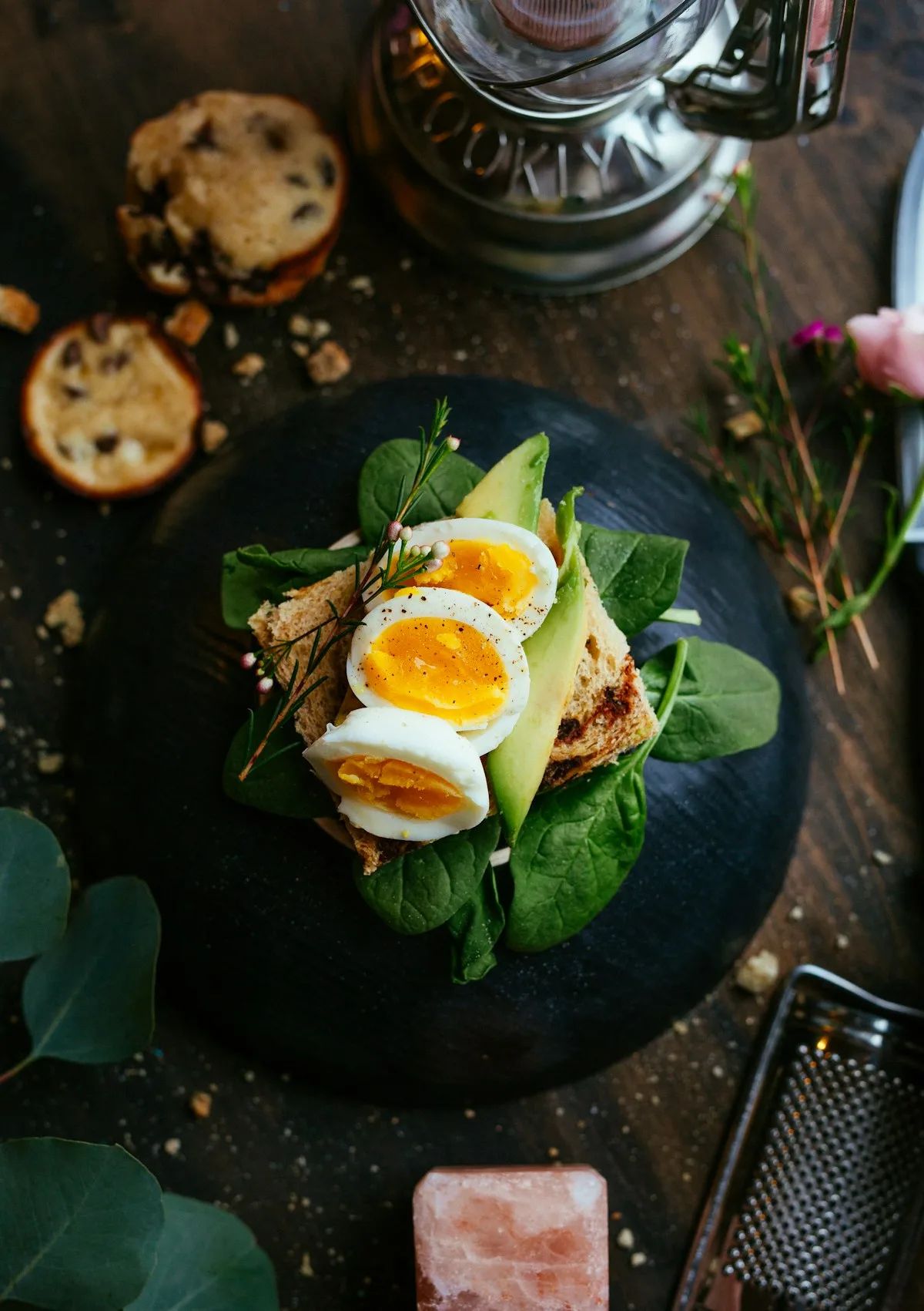 Rustic toast with avocado, egg and fresh green leaves