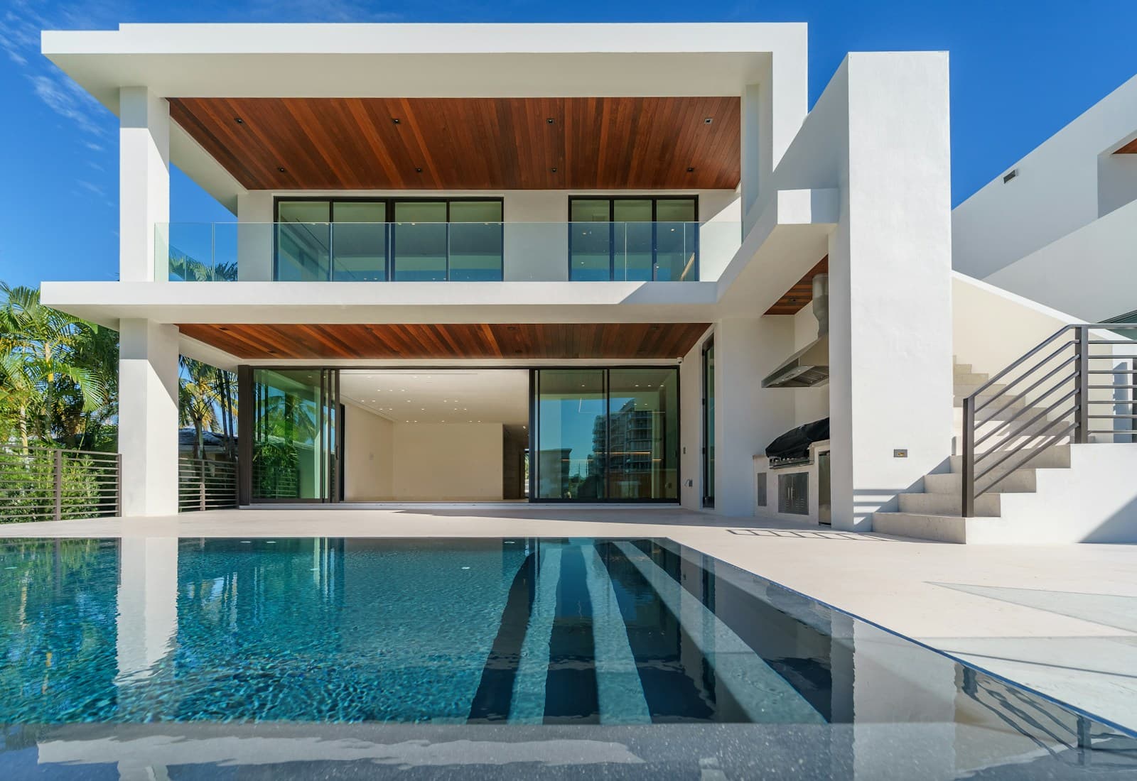 Illustrative modern white villa beside a swimming pool
